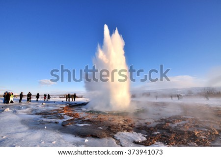 Geyser Park in Iceland. Stokkur eruption with sunstar in a beautiful sunny day in winter.