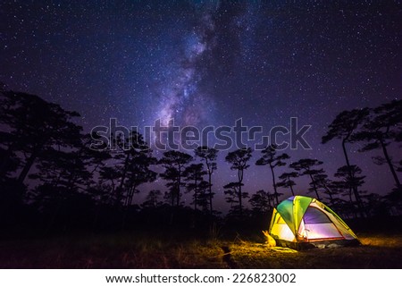 the milky way in front of a tent