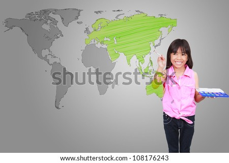 Smiling asian little girl with drawing of the world map on the gray background