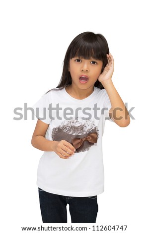 Asian little girl holding her hand to her ear trying to hear you, isolated on white with clipping path