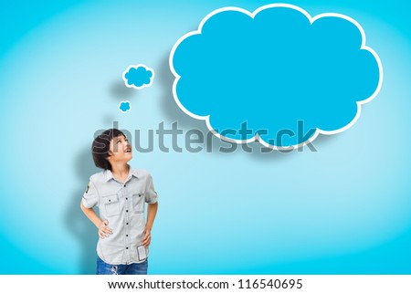 Smile asian boy with empty think bubble on blue background Smile asian boy with empty think bubble on blue background