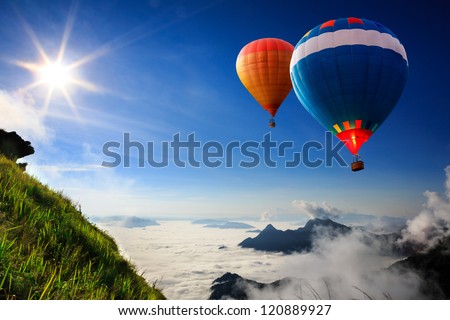 Colorful Hot-Air Balloons Flying Over The Mountain