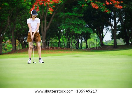 Golf woman player green putting