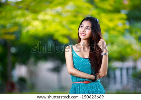 Young asian lady relaxing in the garden