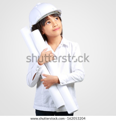 Little Engineer Little girl in the construction helmet with a poster Isolated on grey with clipping path Little Engineer Little girl in the construction helmet with a poster Isolated on grey with clipping path