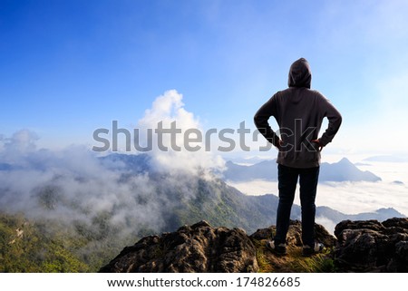 Teenager asian boy standing at mountain, Outdoor portrait