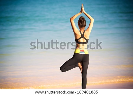 Closeup woman doing exercises on the beach Closeup woman doing exercises on the beach