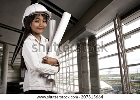 Little engineer, Little girl in the construction helmet with a poster, Building developing construction and architecture concept