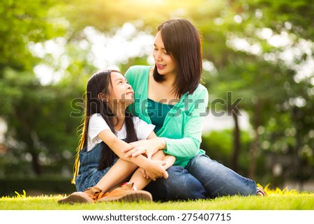 Happy young mother with her daughter at park