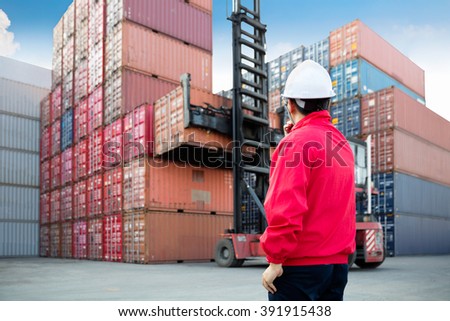 Foreman control loading Containers box from Cargo freight ship