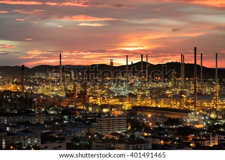 Oil refinery with tube and oil tank at sunset