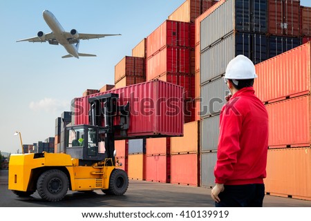 Foreman control loading Containers box from Cargo freight ship, Warehouse shipping transportation concept.