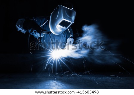 Closeup industrial Worker at the factory welding, Worker welding at industrial factory.