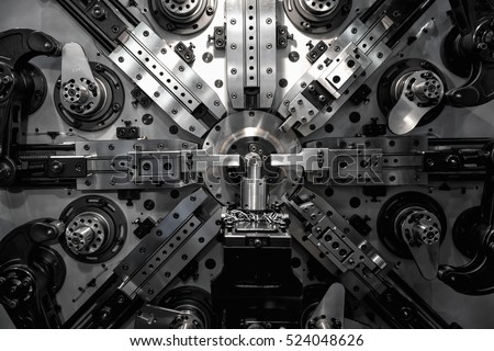 Operator machining automotive part by turning machine, Industry machine background