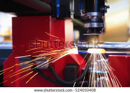 Cutting of sheet metal. Sparks fly from laser by automatic cutting CNC, PLC machine. fabricate work, factory, production