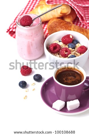 Cup of espresso, muesli, yogurt and croissants