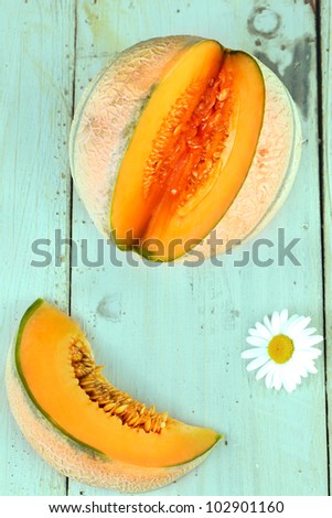 Slice and whole melon on a table