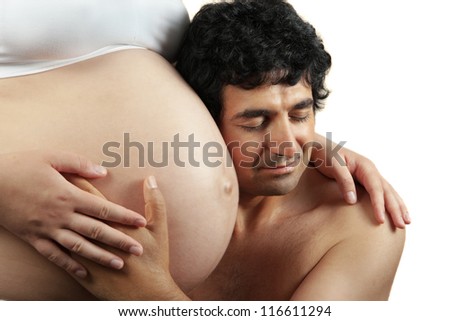 Father hugging pregnant belly of wife. Concept of love, over white background.