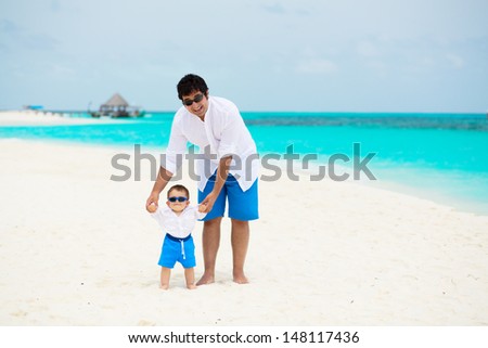 Happy father and son with sun glasses having tropical vacation on Maldives