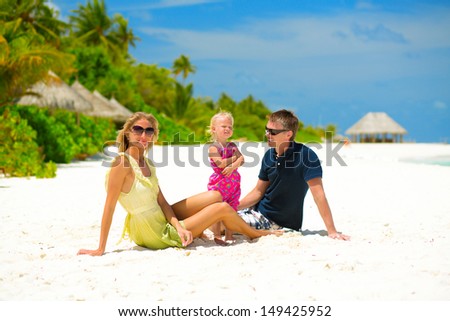 Happy family of three having tropical vacation at Maldives