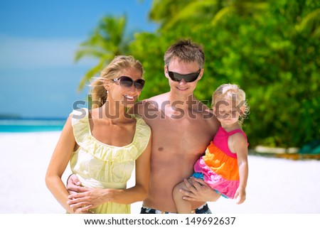 Happy family of three having tropical vacation on Maldives