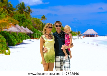 Happy family of three having tropical vacation at Maldives