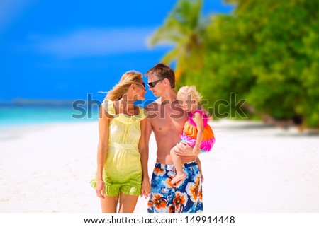 Happy family of three having tropical vacation on Maldives