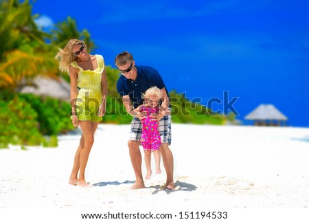 Happy family having fun on tropical beach on Maldives