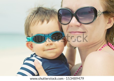 Mother and son on the beach. Close up, face portrait with soft tone effect.
