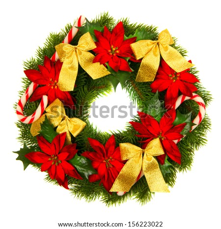 Christmas green wreath from firs brunches with decoration - golden bows, poinsettia flowers and lollipop. Isolated on white background.