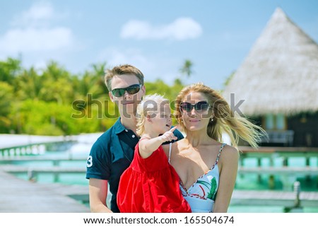 Family of three having tropical vacation on Maldives