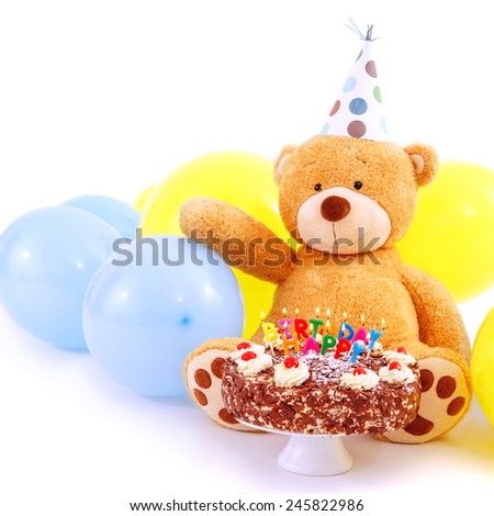 Teddy bear with birthday cap, balloons and cake with candles. Birthday greeting card, isolated, with copy space. Happy birthday cake with burning candles.