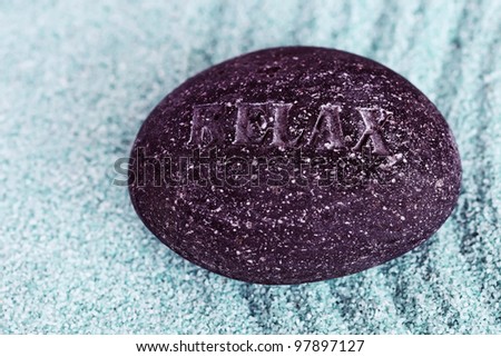 Zen stone relax on a blue sand, concept of relaxation, spa and meditation