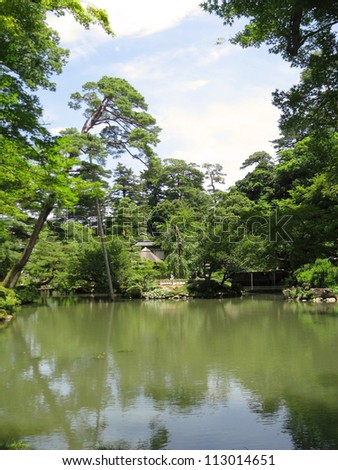 A big pond surrounded by trees in the Kenrokuen Garden - Japan One of the three most beautiful gardens in Japan