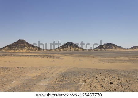 Black desert mountains, Oasis area, Egypt. Black rock was created by the volcanic activity long time ago