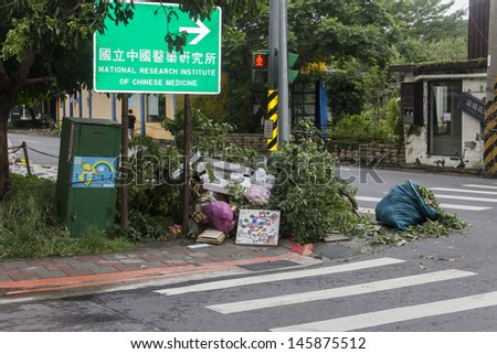 TAIPEI, TAIWAN - JULY 14: Typhoon Soulik hit Taipei city, Taiwan, between July 13th and 14th 2013 causing severe damage. The day after branches, fallen trees and rubbish can be seen on the streets.