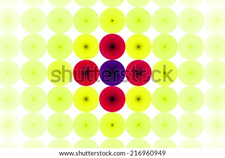 Yellow background in high resolution with an ornamental pattern of discs in rows and columns and with spirals inside them. Spirals in the pastel colored discs in the center are in red and purple