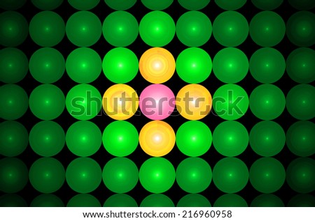 Green background in high resolution with an ornamental pattern of glowing discs in rows and columns and with spirals inside them and center discs being in yellow and pink colors