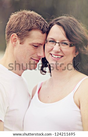 Maternity photos of a couple outdoors in summer time - 8 months pregnant