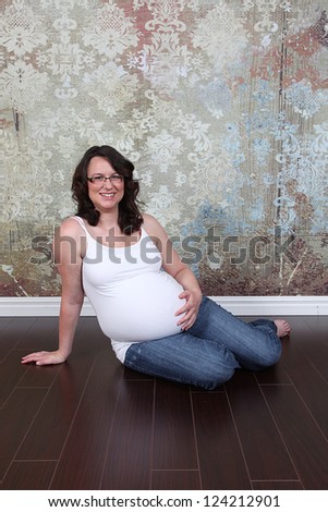 Beautiful pregnant woman 8 months along in studio
