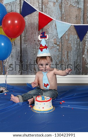 Infant boy\'s first birthday cake smash Adorable baby smashing cake