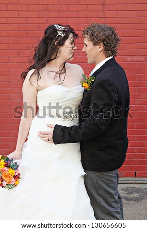 Bride and Groom on wedding Day - Red Brick wall as background