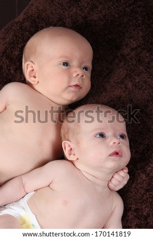 Adorable little brother and Sister twins on studio background