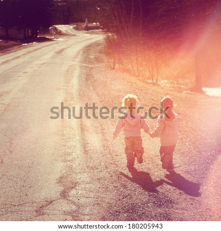 Two girls holding hands walking on road - instagram effect