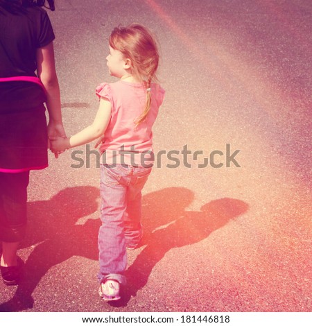 Two girls holding hands walking on road - instagram effect