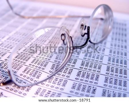 Pair of reading glasses on business book, taken closeup