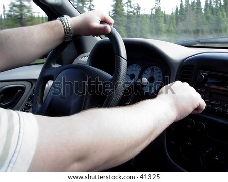 man driving a truck with hands on wheel