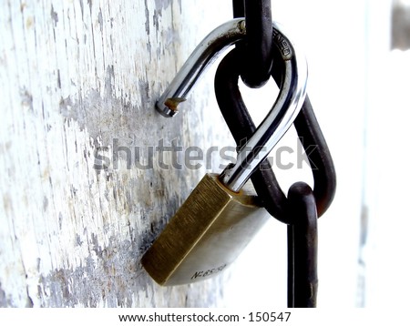 Pad lock on chain on a old door, taken closeup