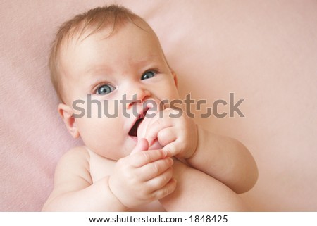 Little Baby Girl with foot in her mouth