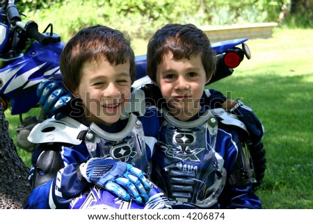 Twin boys together with biking gear on